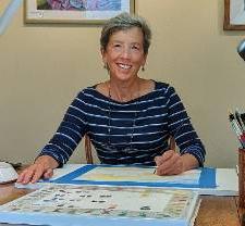 Photo of instructor Beth Owen mid watercolor session with a big smile on her face.